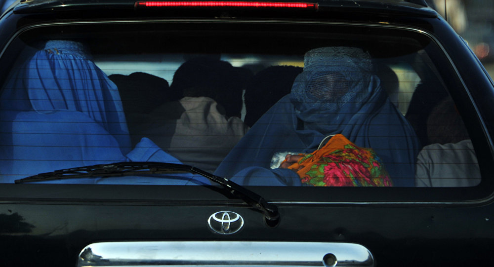 Женщины в парандже на заднем сиденье автомобиля. Архивное