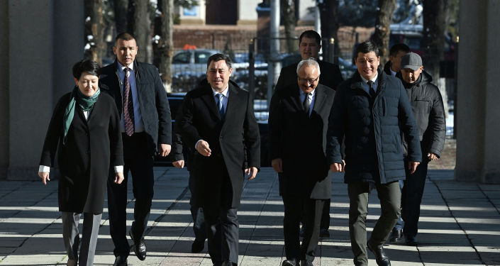Президент Садыр Жапаров и председатель ЦИК Нуржан Шайлдабекова во время ознакомления с ходом готовности к проведению парламентских выборов на примере избирательного участка в Бишкеке. 27 ноября 2021 года