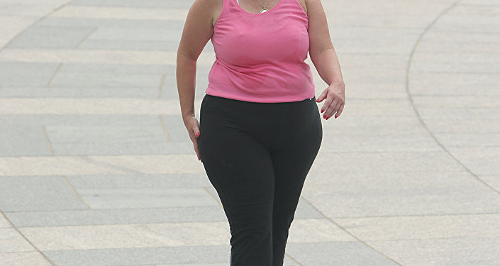 Женщин, страдающая ожирением, идет по улице. Архивное фото