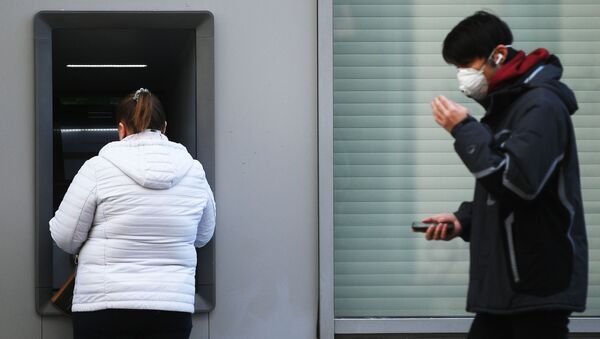 Женщина у банкомата снимает деньги. Архивное фото - Sputnik Кыргызстан