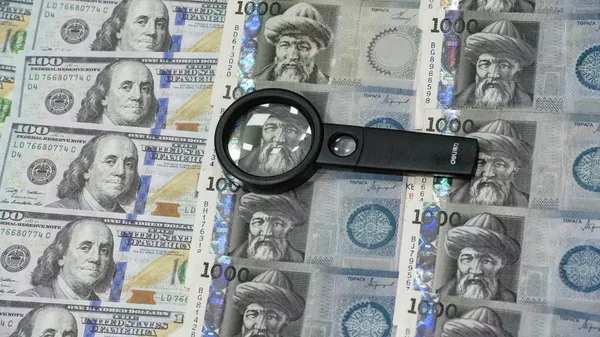 Лупа на сомовых и долларовых купюрах. Иллюстративное фото - Sputnik Кыргызстан