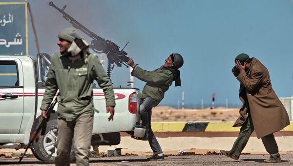 Боец оппозиции стреляет из пулемета в истребитель в городе Рас-Лануф в Ливии. Архивнео фото - Sputnik Кыргызстан