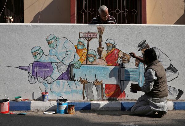 Мужчина рисует граффити, изображающее вакцину от COVID-19, в Калькутте, Индия - Sputnik Кыргызстан