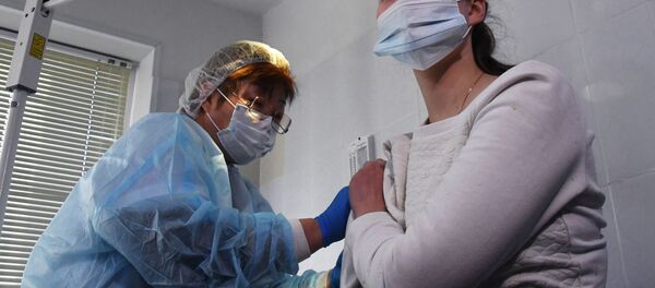 Медицинская сестра вводит вакцину Гам-КОВИД-Вак медработнику в поликлинике №6 Владивостока. - Sputnik Кыргызстан