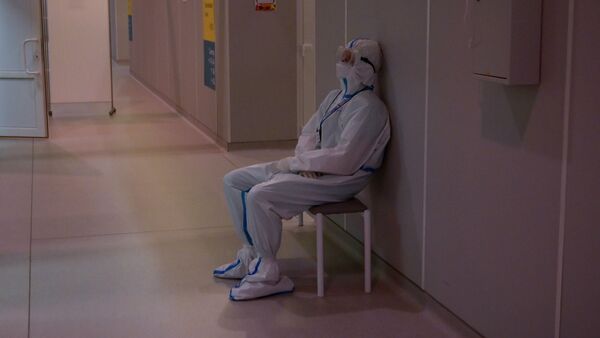 Медицинский работник в СИЗ в холле госпиталя для больных COVID-19 - Sputnik Кыргызстан