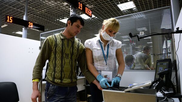 Посетитель в многофункционального миграционного центра проходит процедуру дактилоскопии. Архивное фото - Sputnik Кыргызстан