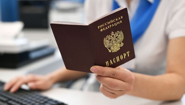 Государственный служащий держит в руках паспорт РФ - Sputnik Кыргызстан