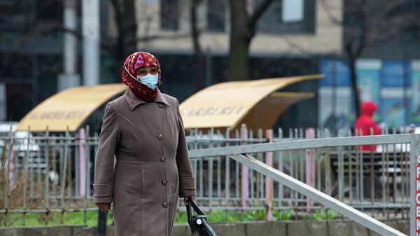 Женщина в медицинской маске идет на одной из улиц Бишкека - Sputnik Кыргызстан