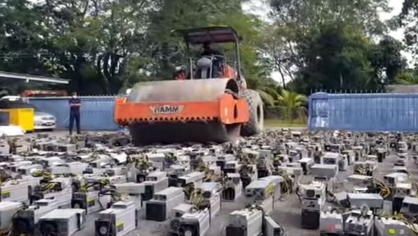 В Малайзии асфалтоукладочным катком раздавили тысячи ASIC-майнеров. Видео - Sputnik Кыргызстан