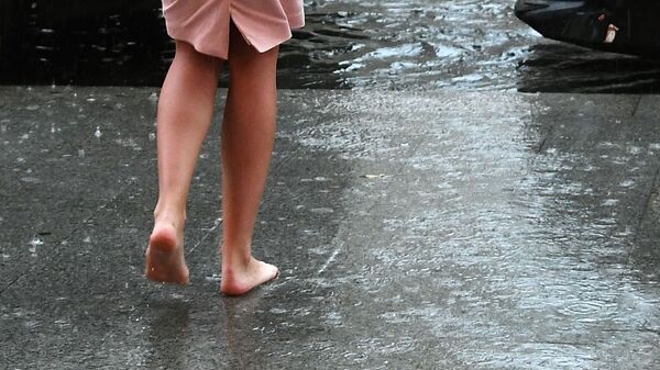 Девушка на одной из улиц города во время дождя. Архивное фото - Sputnik Кыргызстан