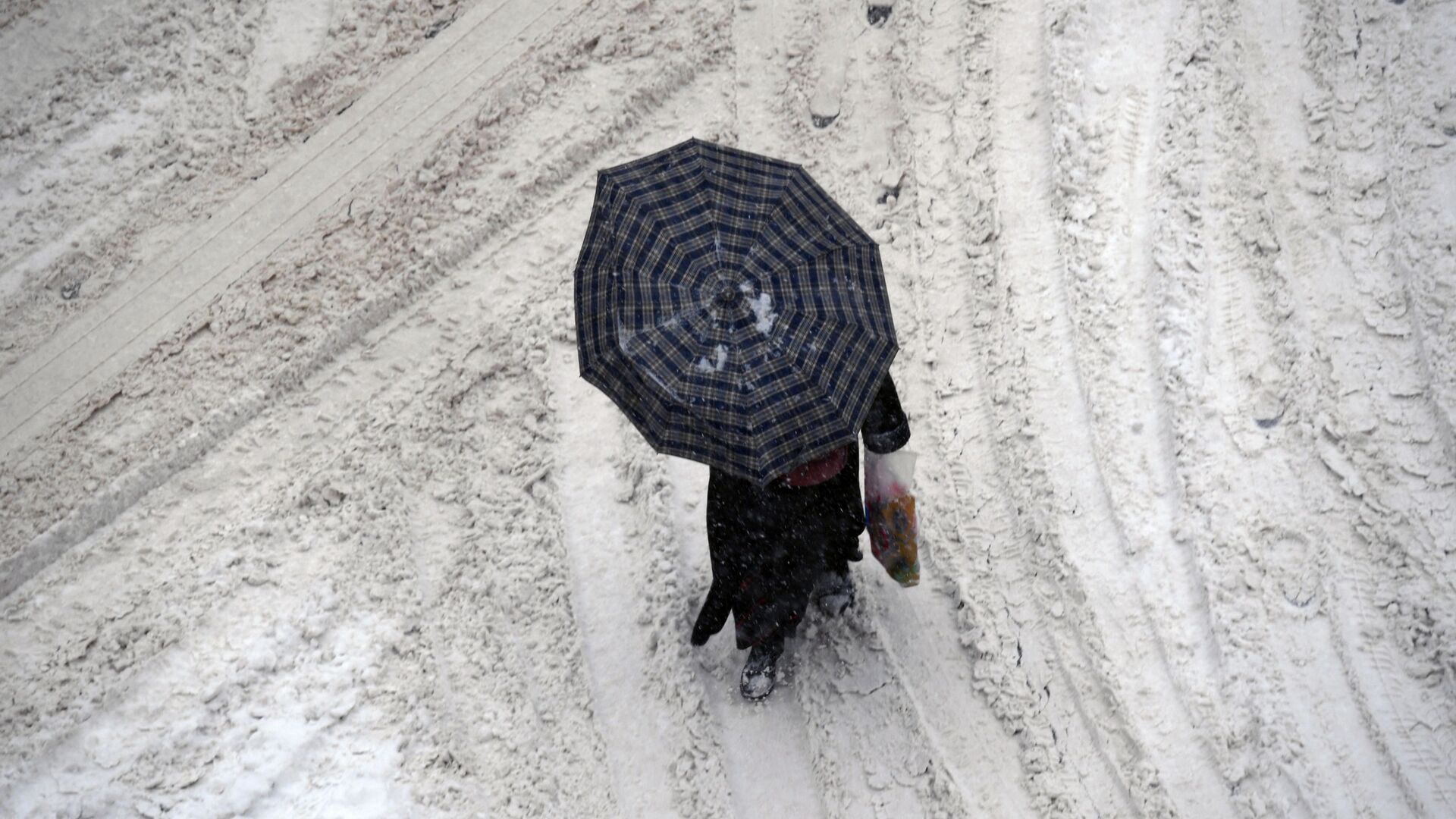 Женщина под зонтом во время снегопада - Sputnik Кыргызстан, 1920, 08.12.2021
