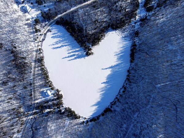 Снег покрывает ледяной пруд Бейкер в форме сердца в Квебеке (Канада) - Sputnik Кыргызстан