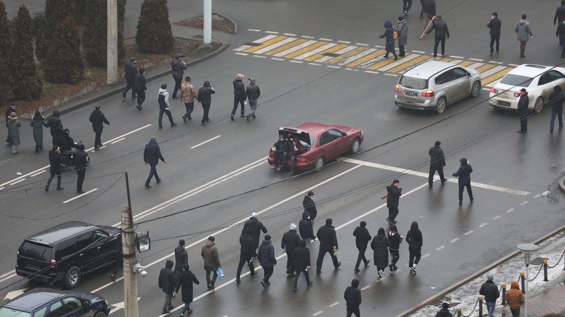 Демонстранты идут по улице во время акции протеста, вызванной повышением цен на топливо в Алматы - Sputnik Кыргызстан, 1920, 06.01.2022