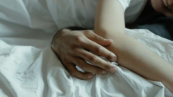 Мужчина и женщина лежат на кровати. Иллюстративное фото - Sputnik Кыргызстан