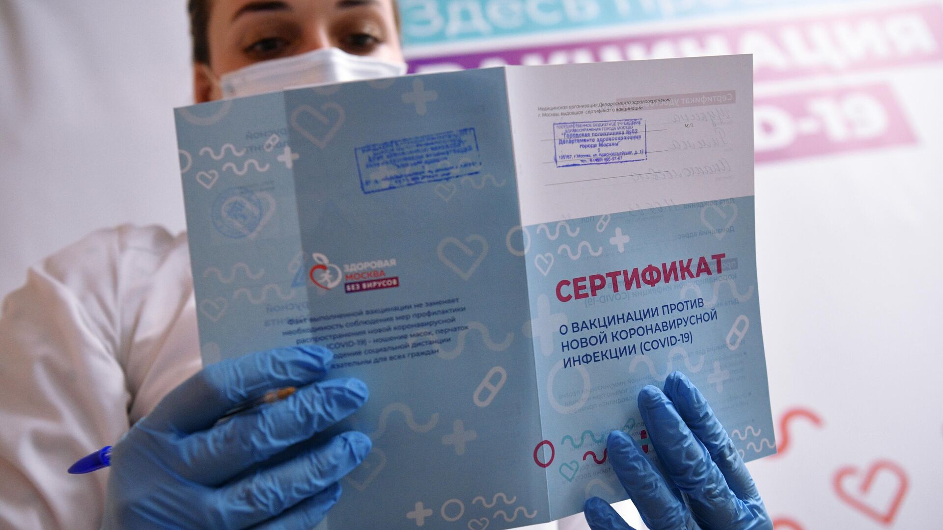 Медицинский работник держит в руках сертификат о вакцинации. Архивное фото - Sputnik Кыргызстан, 1920, 21.02.2022