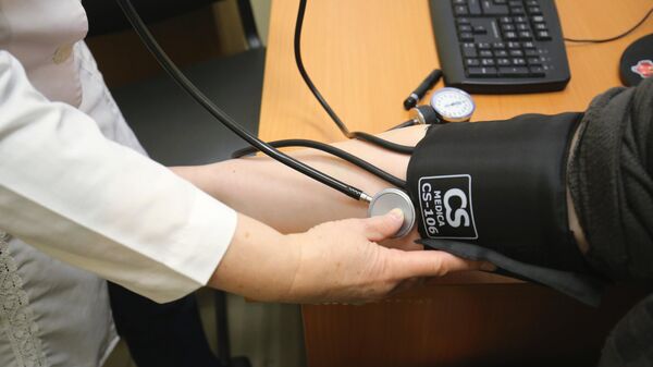 Врач измеряет артериальное давление пациенту. Архивное фото - Sputnik Кыргызстан