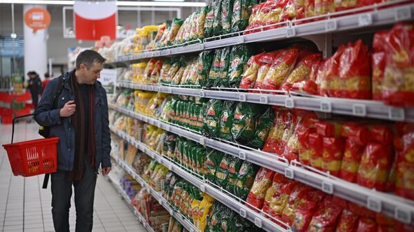 Мужчина выбирает макароны в гипермаркете  - Sputnik Кыргызстан