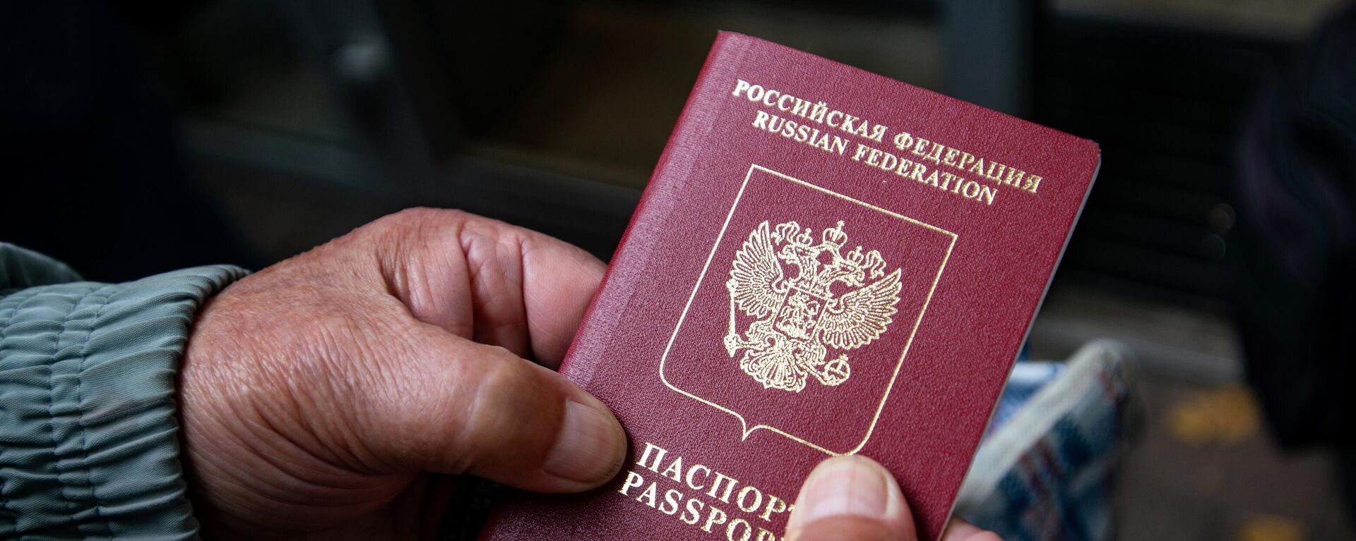 Мужчина держит в руках паспорт РФ. Архивное фото - Sputnik Кыргызстан, 1920, 25.05.2022