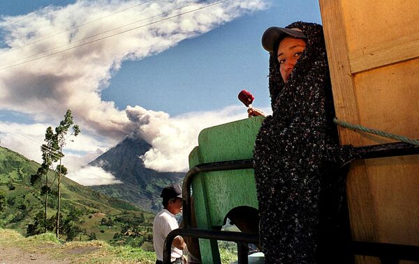 Женщина ест мороженое во время извержения вулкана Тунгурауа (Патате). 1999 - Sputnik Кыргызстан