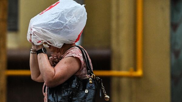 Женщина идет по улице во время дождя. Архивное фото - Sputnik Кыргызстан