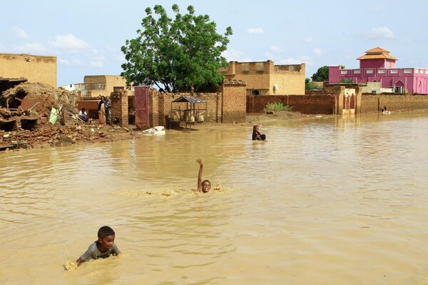 Суданские дети купаются в паводковой воде в городе Iboud - Sputnik Кыргызстан