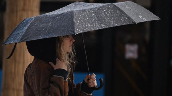 Девушка идет с зонтом во время дождя. Архивное фото - Sputnik Кыргызстан