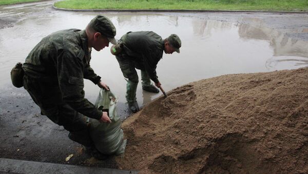 Военнослужащие наполняют мешки песком для сооружения противопаводковых заграждений . Архивное фото - Sputnik Кыргызстан