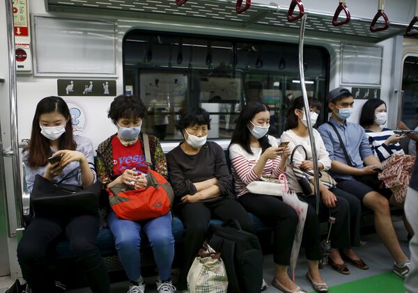 Пассажиры в метро Сеула в медицинских масках - Sputnik Кыргызстан