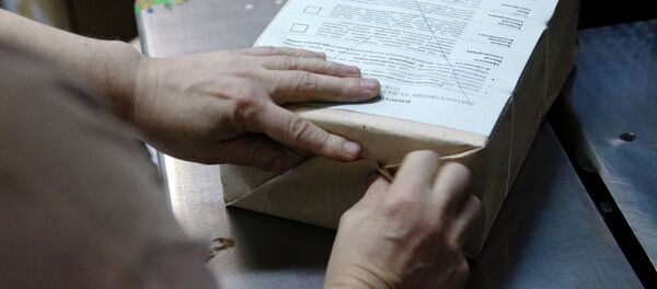 Сотрудник типографии упаковывает нарезанные избирательные бюллетени. Архивное фото - Sputnik Кыргызстан