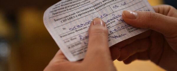 Человек держит справку о прохождении биометрической регистрации. Архивное фото - Sputnik Кыргызстан