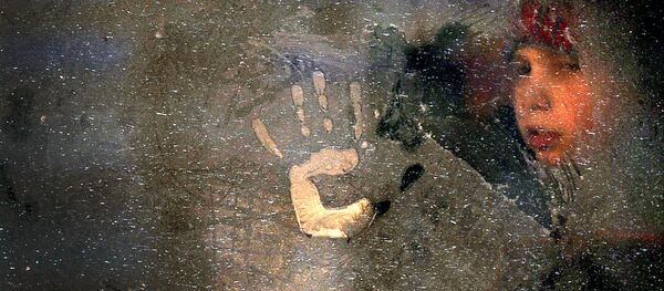 Мальчик смотрит через замерзшее окно. Архивное фото - Sputnik Кыргызстан