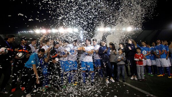 Футболисты с трофеем, после того, как играли футбольный матч 120-часовой, чтобы побить рекорд Гиннеса в Сантьяго. - Sputnik Кыргызстан