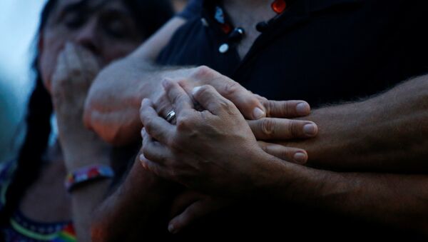 Партнеры держатся за руки после стрельбы в ночном клубе в Орландо, США. - Sputnik Кыргызстан