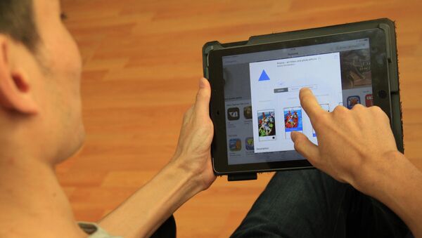 Пользователь с планшетом устанавливает приложение Prisma. Архивное фото - Sputnik Кыргызстан