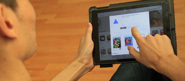Пользователь на планшете устанавливает приложение Prisma. Архивное фото - Sputnik Кыргызстан