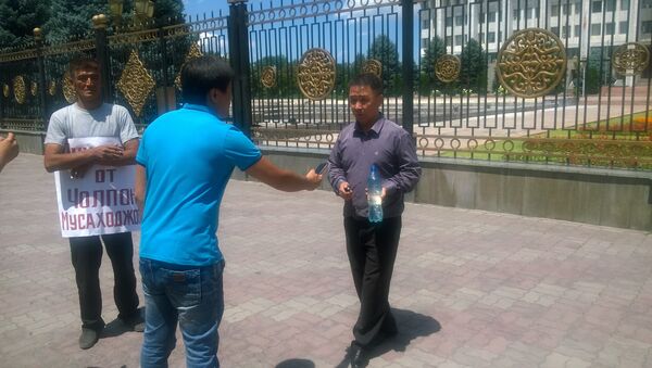Неизвестный мужчина, который грозится поджечь себя на центральной площади Ала-Тоо в Бишкеке. - Sputnik Кыргызстан