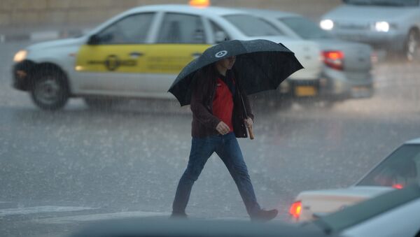 Мужчина идет под зонтом во время сильного дождя. Архивное фото - Sputnik Кыргызстан