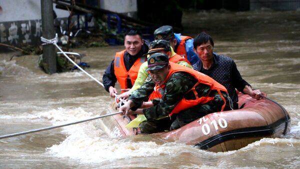 Китайские спасатели эвакуируют жителей из затопленного района. Архивное фото - Sputnik Кыргызстан