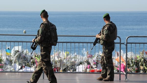 Французские солдаты проходят мимо импровизированного мемориала в память жертв теракта в День взятия Бастилии на Английском набережной в Ницце. Архивное фото - Sputnik Кыргызстан