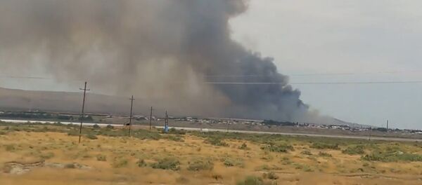 Густой дым поднялся над зданием оружейного склада в Азербайджане после взрыва Густой дым поднялся над зданием оружейного склада в Азербайджане после взрыва - Sputnik Кыргызстан