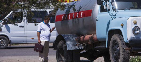 Сотрудник госэкотехинспекции во время рейда по точкам незаконной продажи газа Сотрудник госэкотехинспекции во время рейда по точкам незаконной продажи газа - Sputnik Кыргызстан