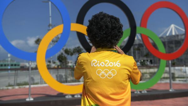 Мужчина у олимпийских колец в Олимпийском парке в Рио-де-Жанейро. Архивное фото - Sputnik Кыргызстан