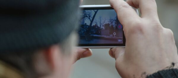 Телефонго тартып жаткан адам. Архив - Sputnik Кыргызстан