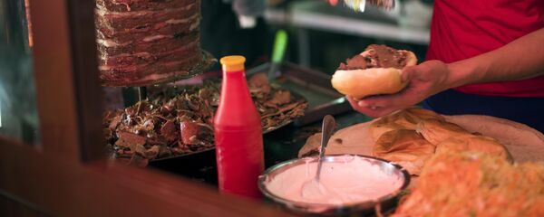 Мужчина готовит гамбургер в одном из фастфудов Бишкека. Архивное фото - Sputnik Кыргызстан