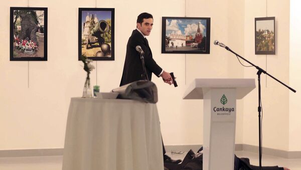 Вооруженный мужчина рядом с телом посла России в Турции Андрея Карлова в галерее в Анкаре - Sputnik Кыргызстан