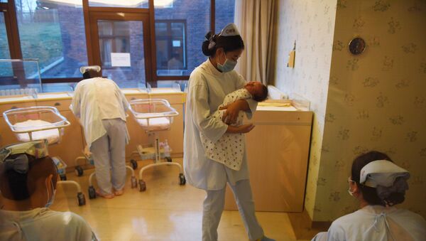 Сотрудница родильного дома с младенцем на руках. Архивное фото - Sputnik Кыргызстан