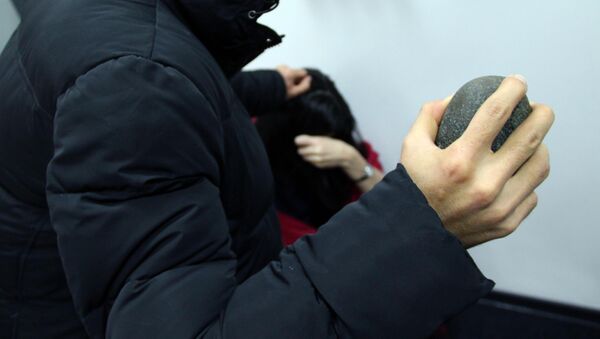 Мужчина с камнем в руках имитирует нападение на женщину. Иллюстративное фото - Sputnik Кыргызстан