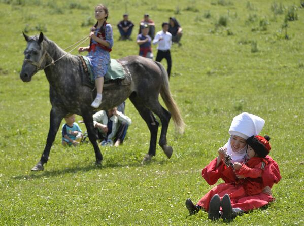 Чуңкурчак капчыгайындагы фестивалда бөбөгүн ойнотуп жаткан бийкеч - Sputnik Кыргызстан