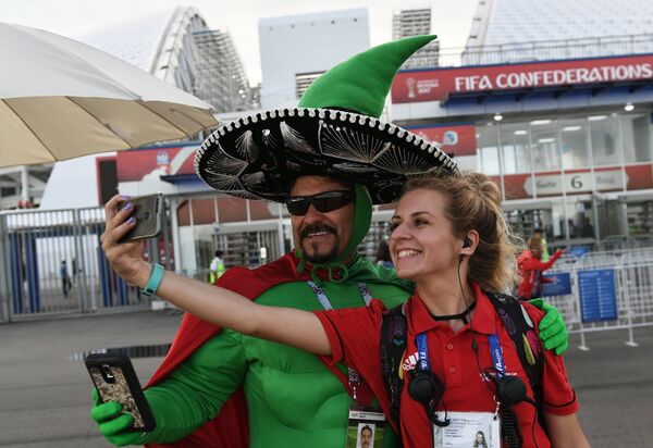 Мексиканский болельщик фотографируется с волонтером перед началом матча между сборными Мексики и Новой Зеландии. - Sputnik Кыргызстан