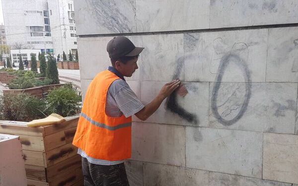 Работники муниципального предприятия Тазалык не смогли оттереть надписи на стенах здания у площади Ала-Тоо в Бишкеке - Sputnik Кыргызстан